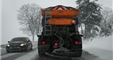 snowplow in right lane plowing and spreading salt
